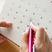 hands circling date on calendar