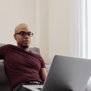 man reading news on laptop