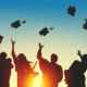 graduates tossing caps in air
