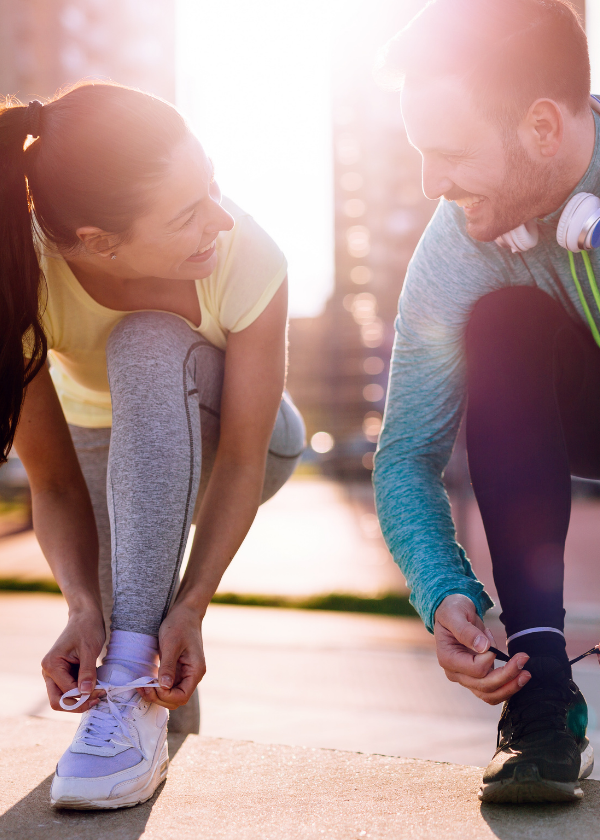 runners lacing up shoes