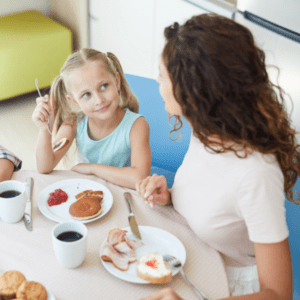 mom and daughters at breakfast