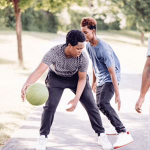 teens playing basketball
