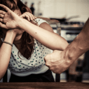 man with fist and woman putting hands up