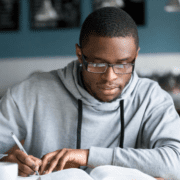 student with glasses studying