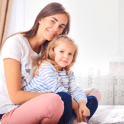 Mom and Child sitting on bed stock file