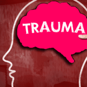 head drawn with hand holding brain shaped red trauma sign