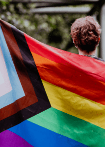 person holding LGBTQIA2+ flag