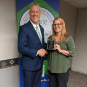 CEO Larry Williams and Amy Nelson with work anniversary plaque