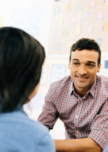 stock image young male therapist talking to youth