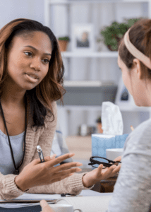 female outpatient therapist talking to female client stock image