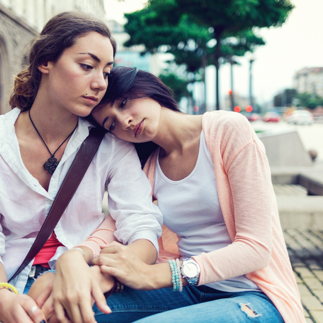 two female friends looking somber