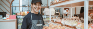 worker smiling at bakery